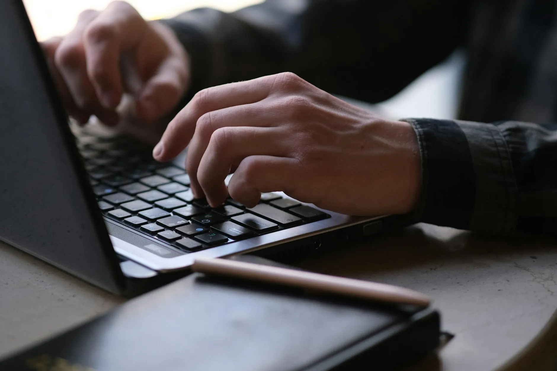 Detail shot of a student using digital tools to organize study materials