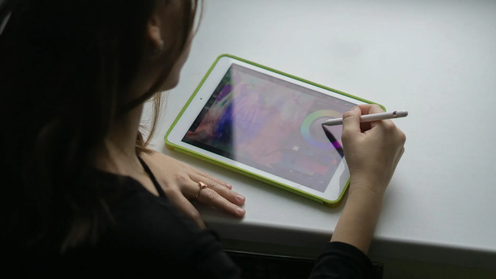 Close up of a student using a tablet for digital flashcards on a desk with a coffee mug
