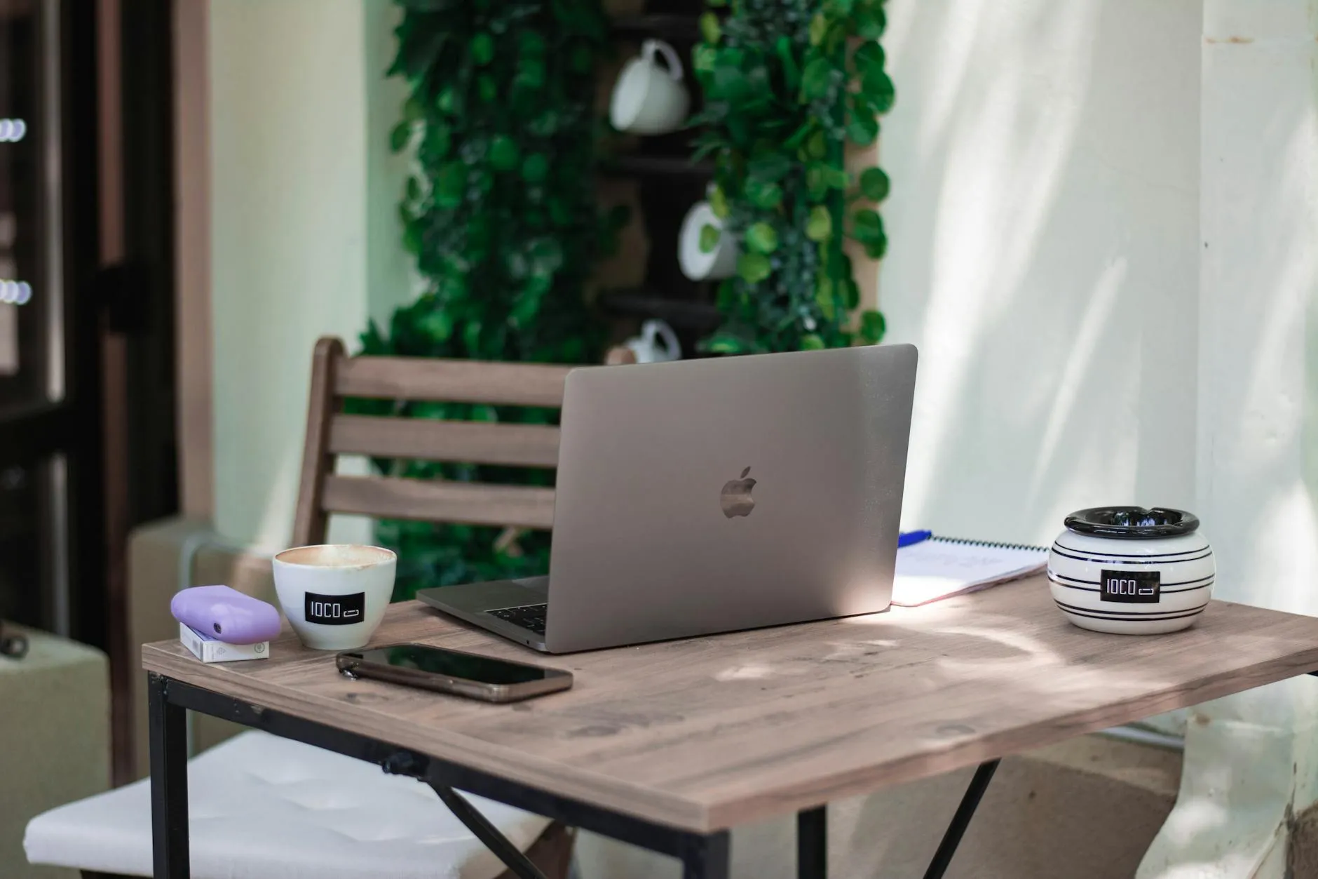 A realistic Gen Z student study desk in a dorm room with a laptop, coffee, and scattered notebooks.