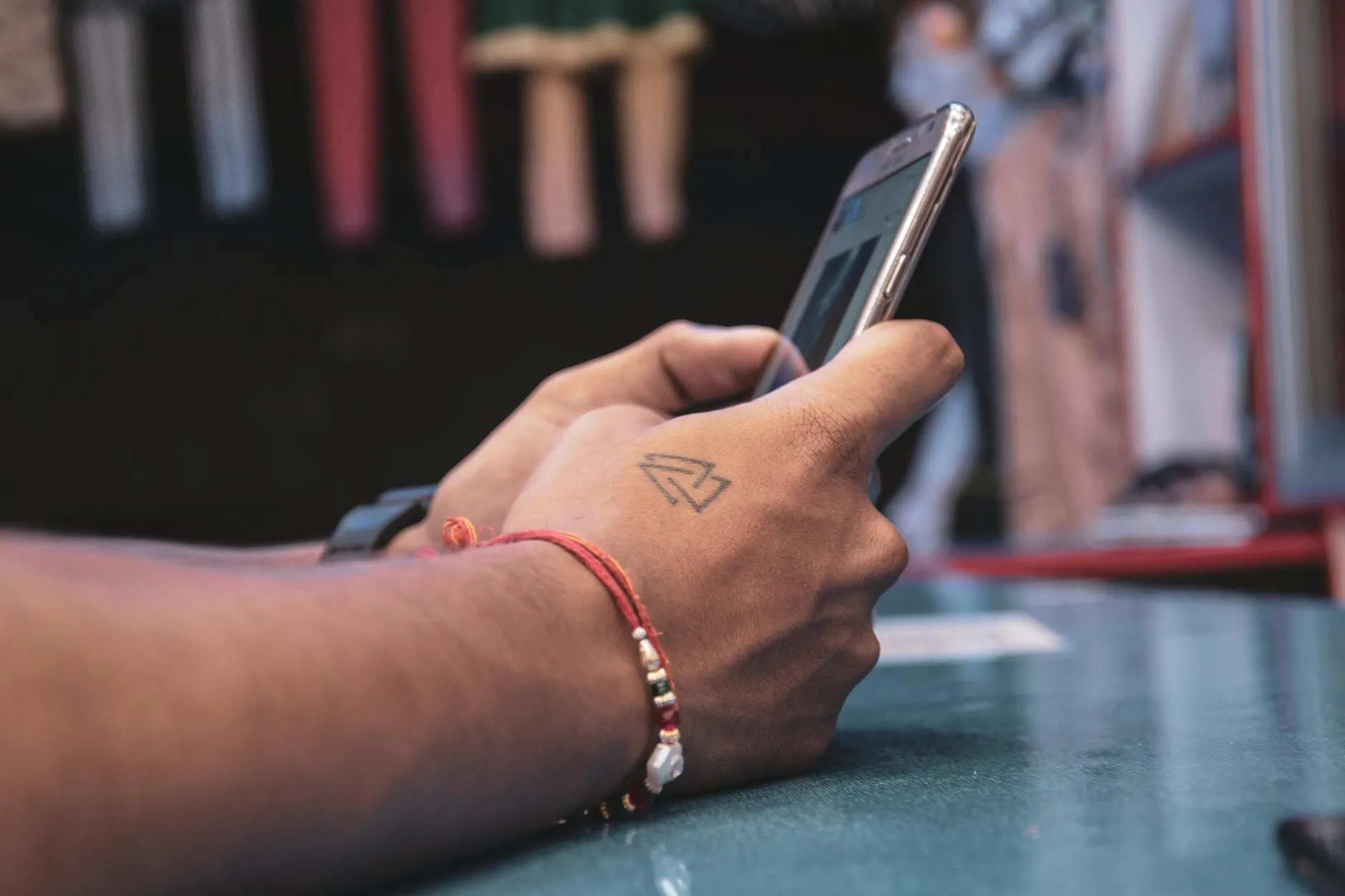Detail shot of a student using a study app on their phone in a modern library