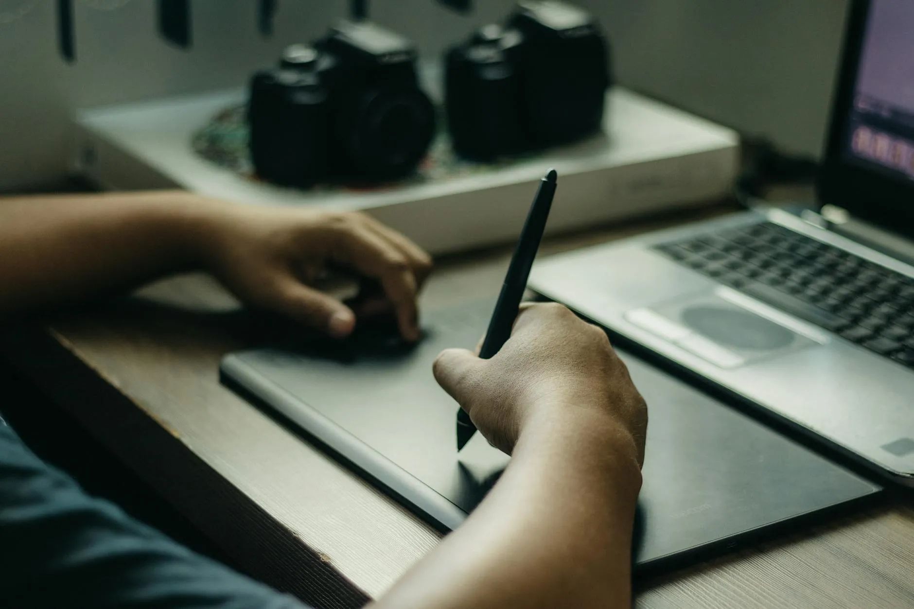 Close up of a student using a tablet and digital pen to organize study notes on a messy wooden desk