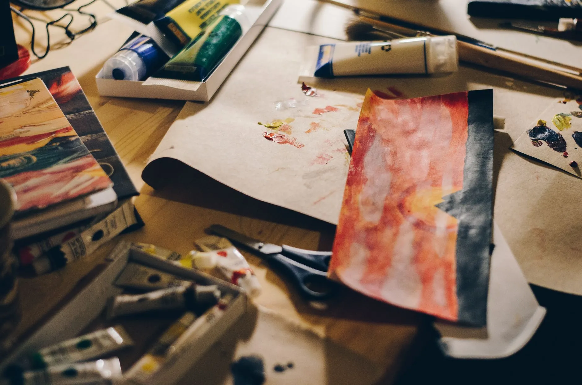 Close up of a student using a tablet to organize digital flashcards on a messy wooden dorm desk