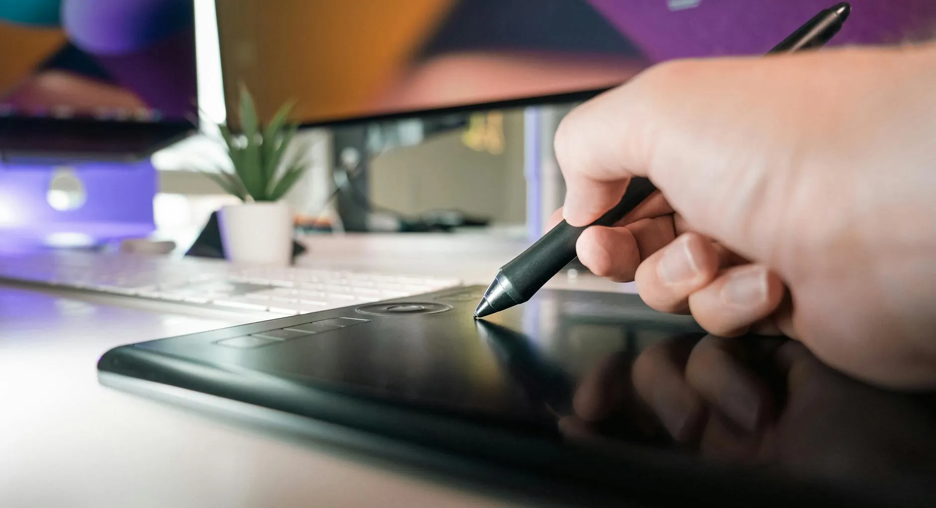 Close-up of student's hands creating digital flashcards on a tablet at a cluttered dorm room desk.