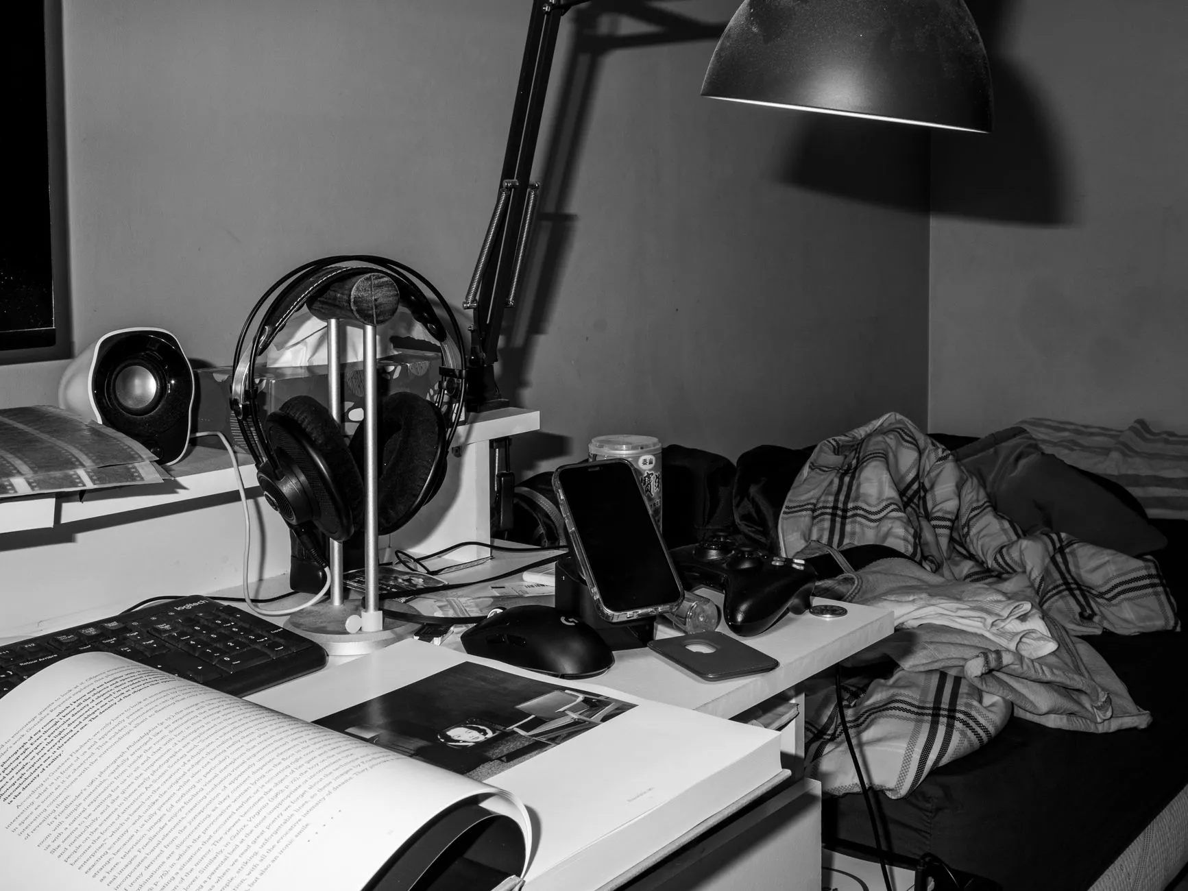 Close up of student hands organizing digital flashcards on a tablet at a messy dorm room desk