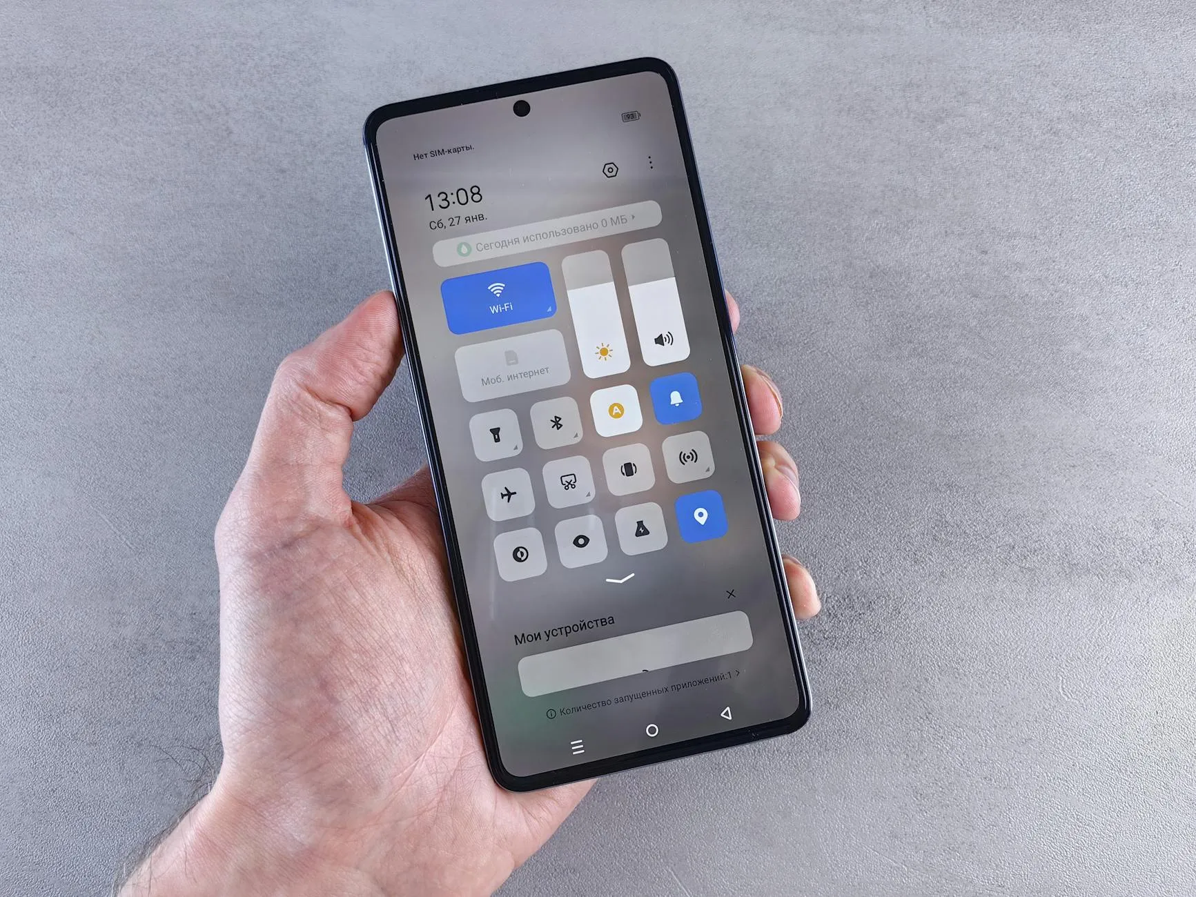 Close-up of a student's hands using a microlearning app on a tablet in a dorm room.