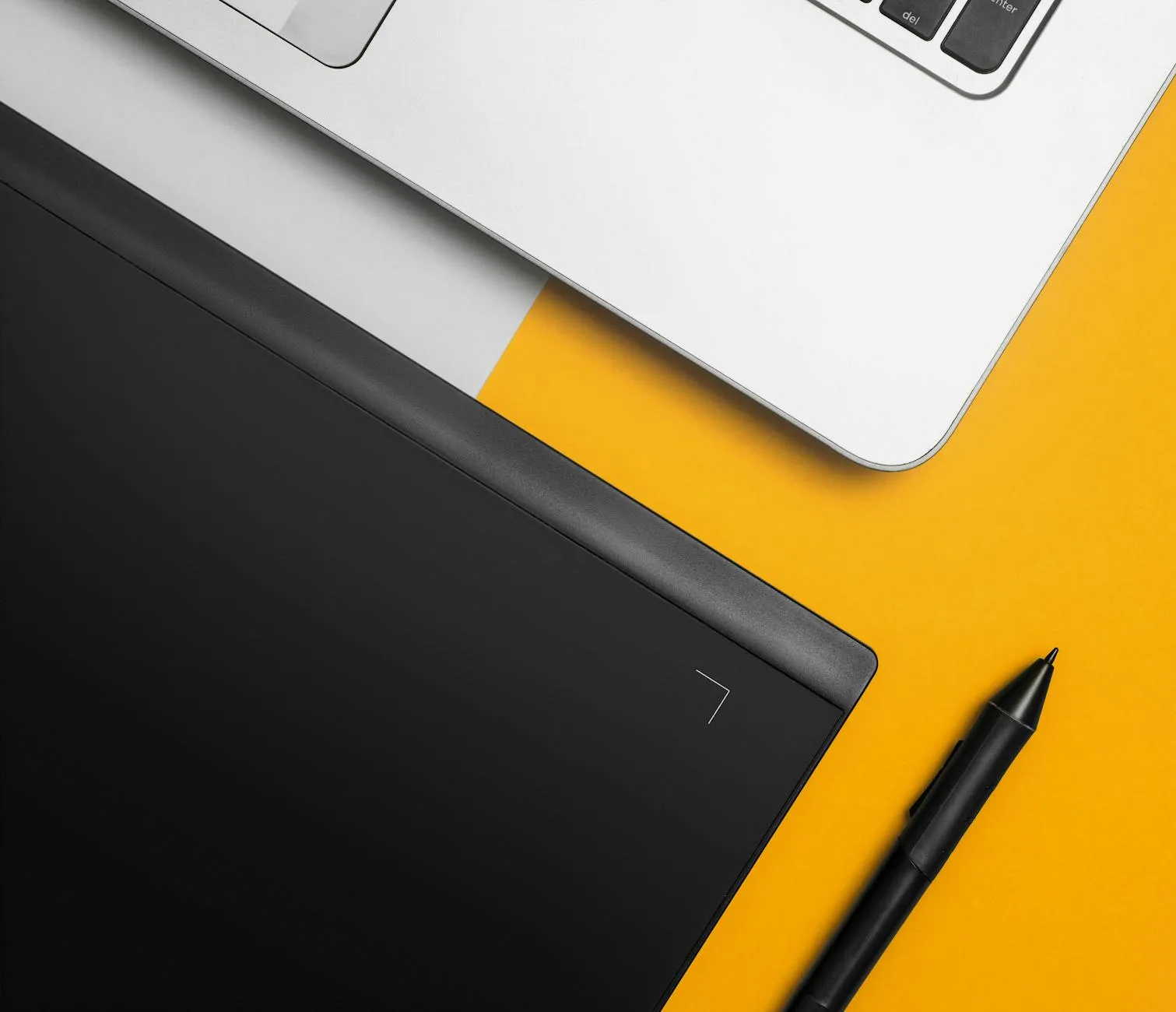 Close-up of a student's hands creating digital flashcards on a tablet at a cluttered dorm room desk.