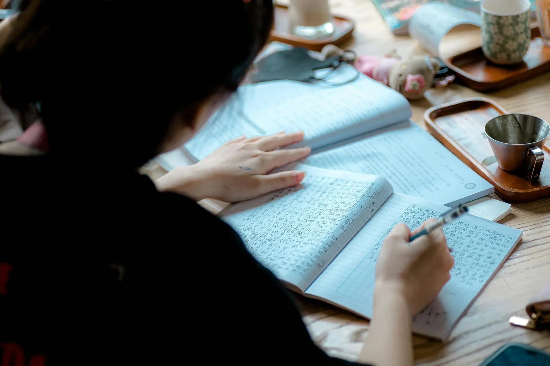 A cozy student dorm room desk with a laptop open showing study notes next to a window