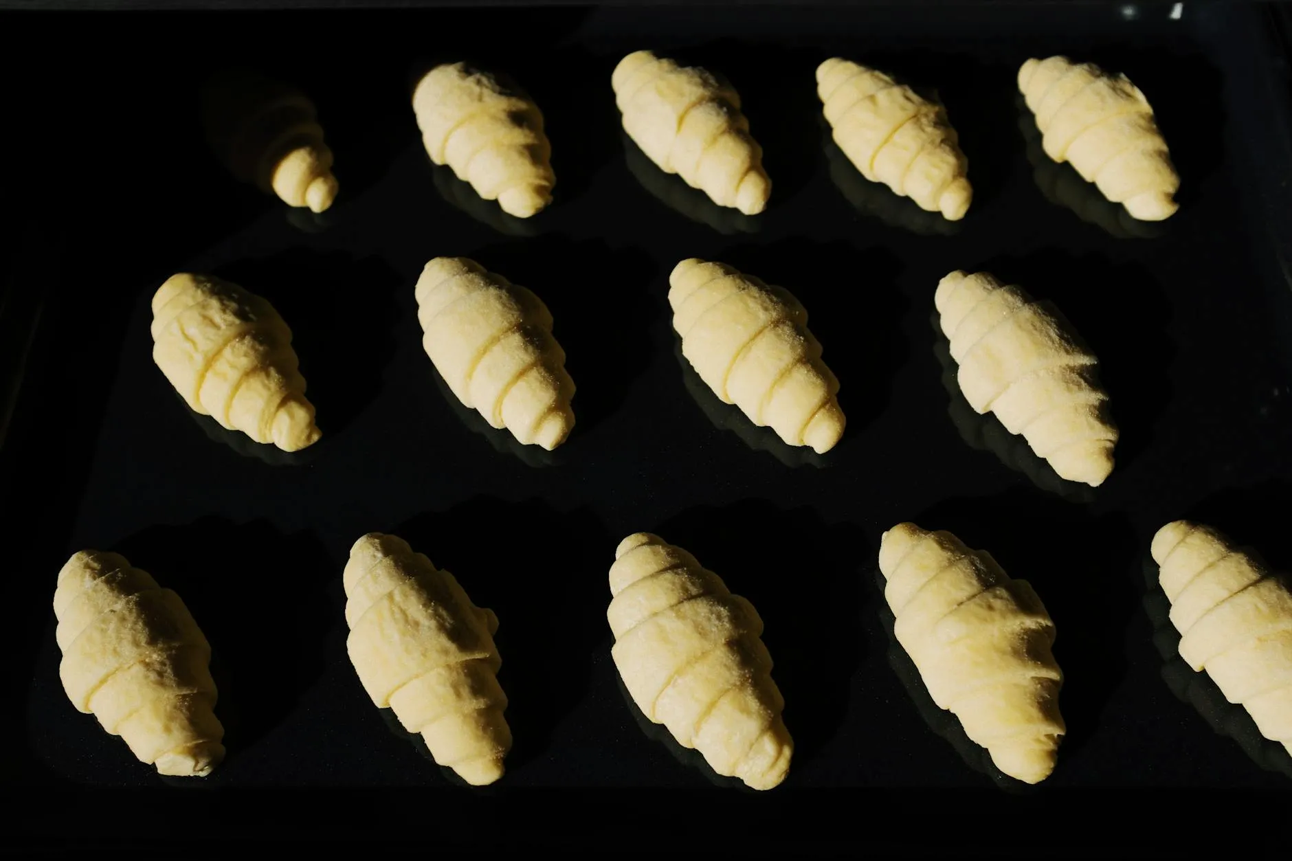 Close-up of a student's hands interacting with a tablet on a cluttered dorm desk