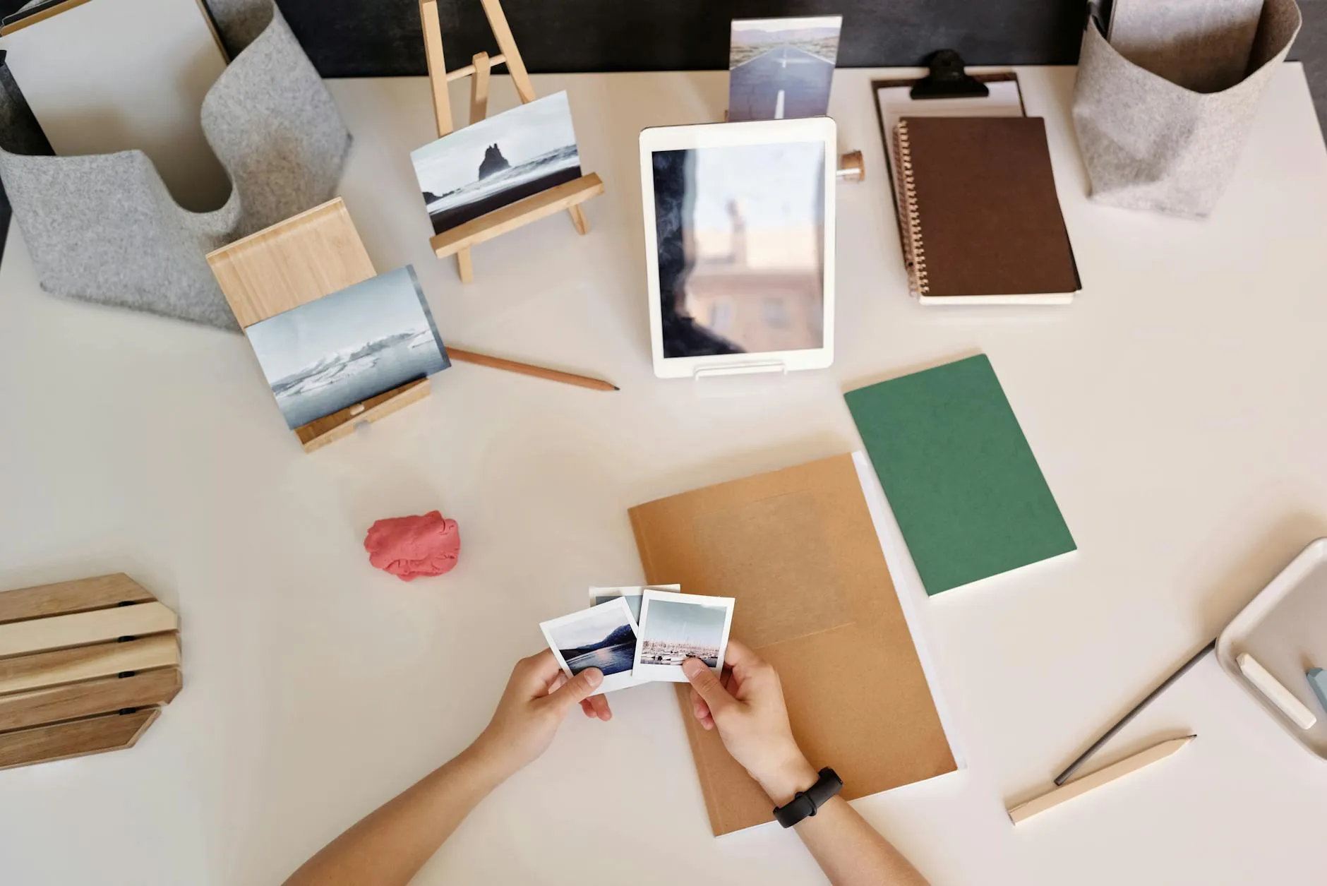 Close up of a student using a tablet to review digital flashcards on a desk with books and a lamp