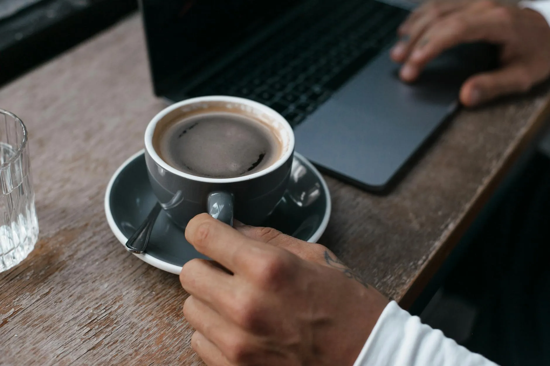 Close up of a student working on a laptop in a modern university library