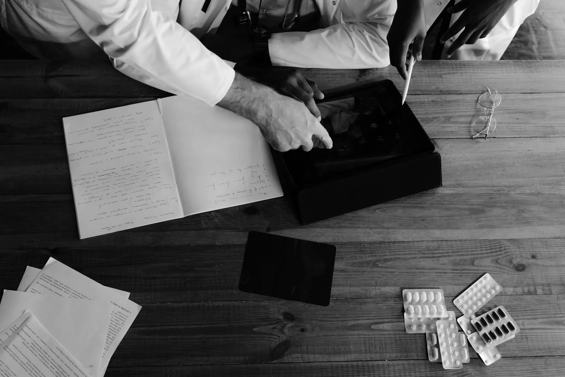 Close up of a student using a tablet to create study materials on a messy dorm room desk