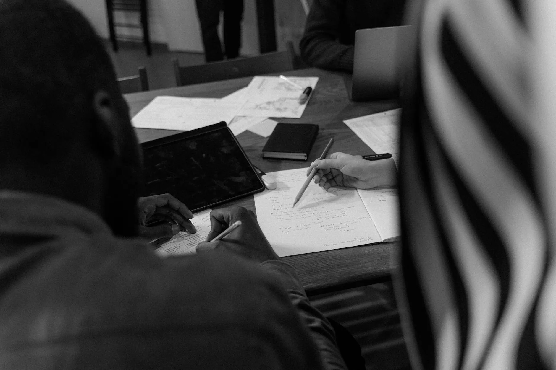 Student using a tablet to study with digital flashcards on a messy desk