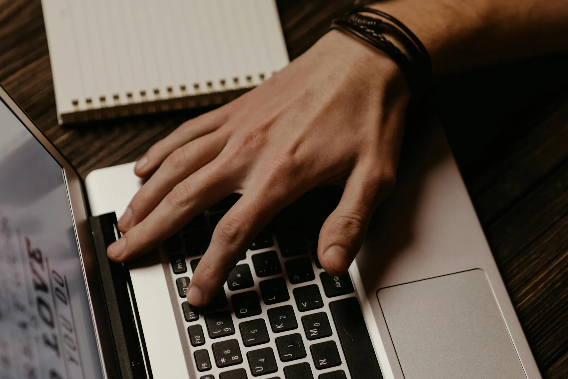 A student in gym clothes working on a laptop in a campus coffee shop, demonstrating how movement can fit into a productive study routine.
