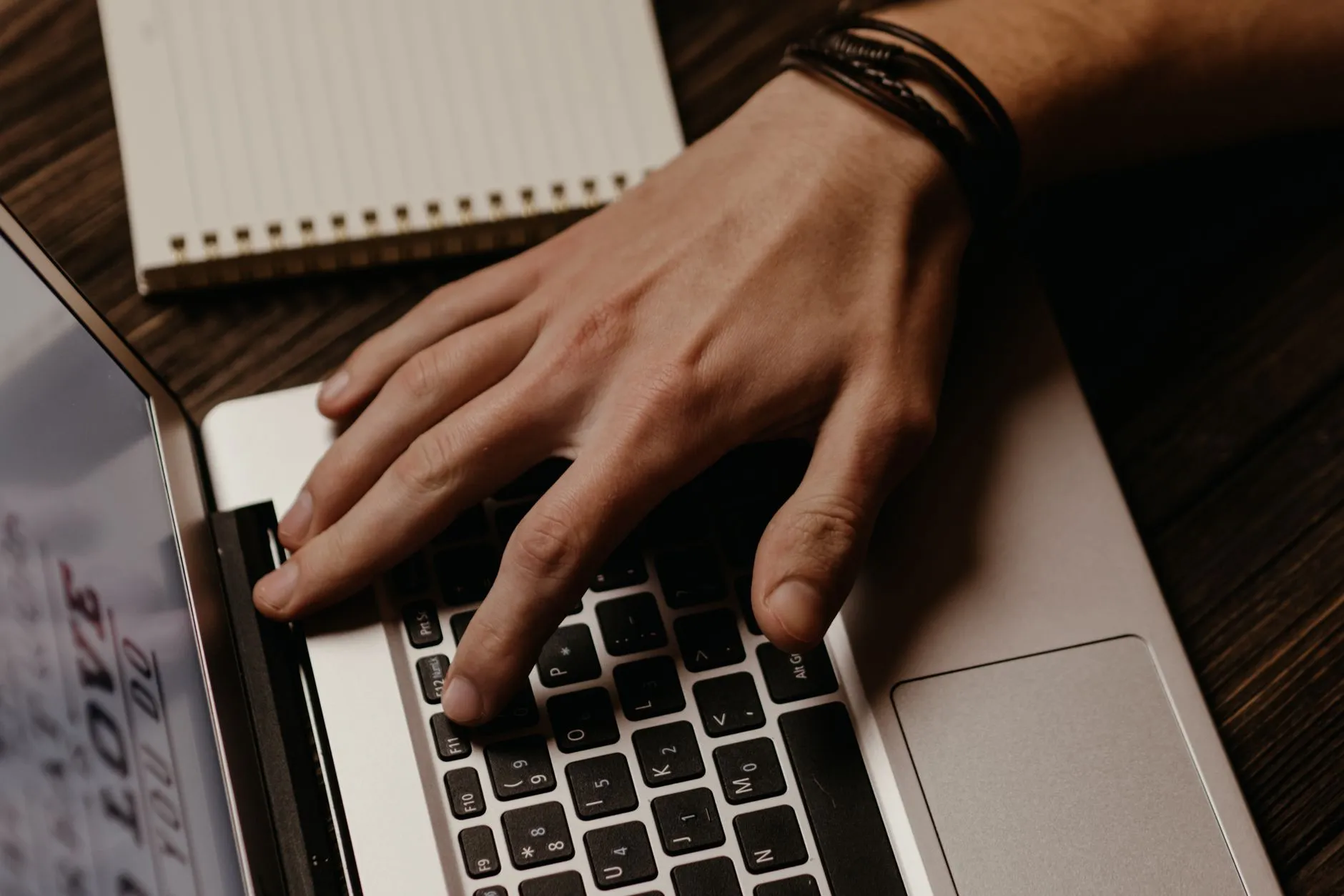 Close up of hands typing on a laptop displaying a university acceptance email