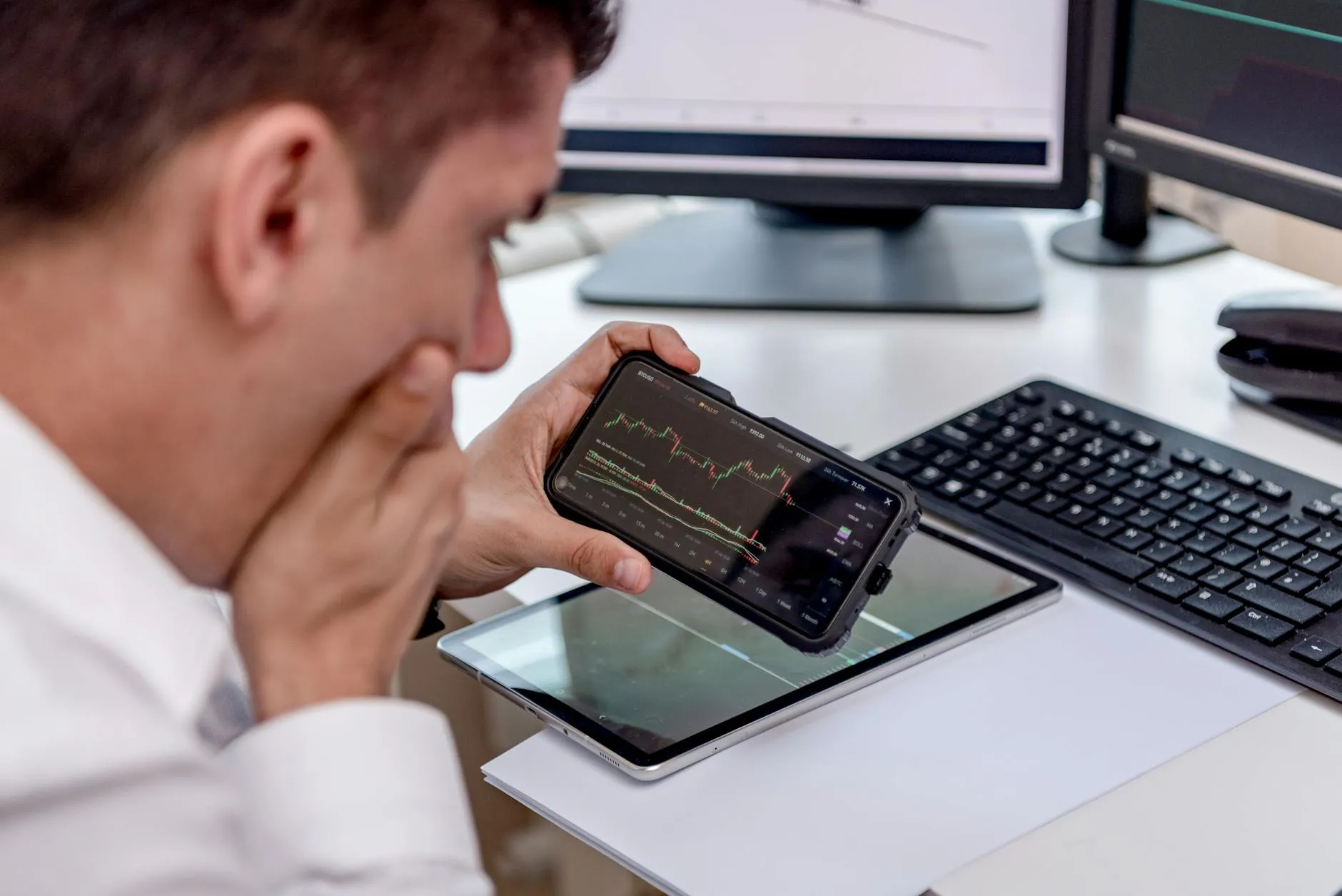 Close-up of a student's hands quickly generating flashcards on a tablet at a messy dorm desk during an urgent study session