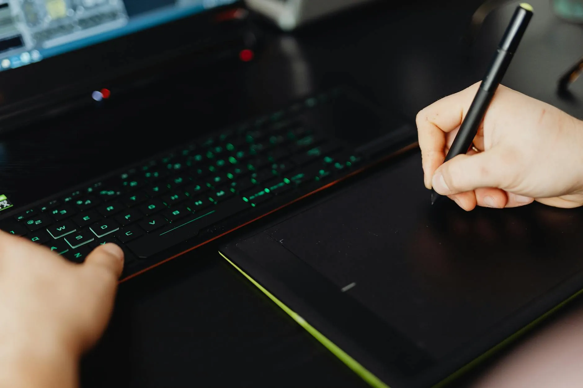 Close-up of student's hands creating digital flashcards on a tablet at a cluttered desk