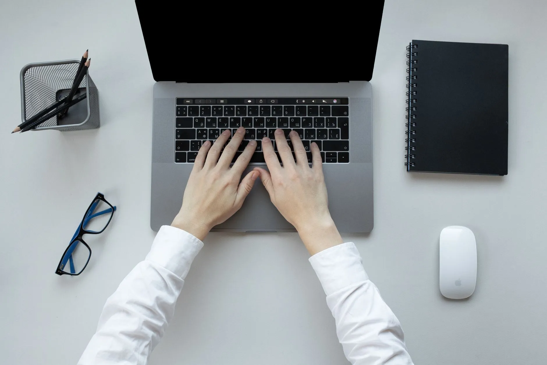Close up of a student using an active recall website on a laptop surrounded by notebooks