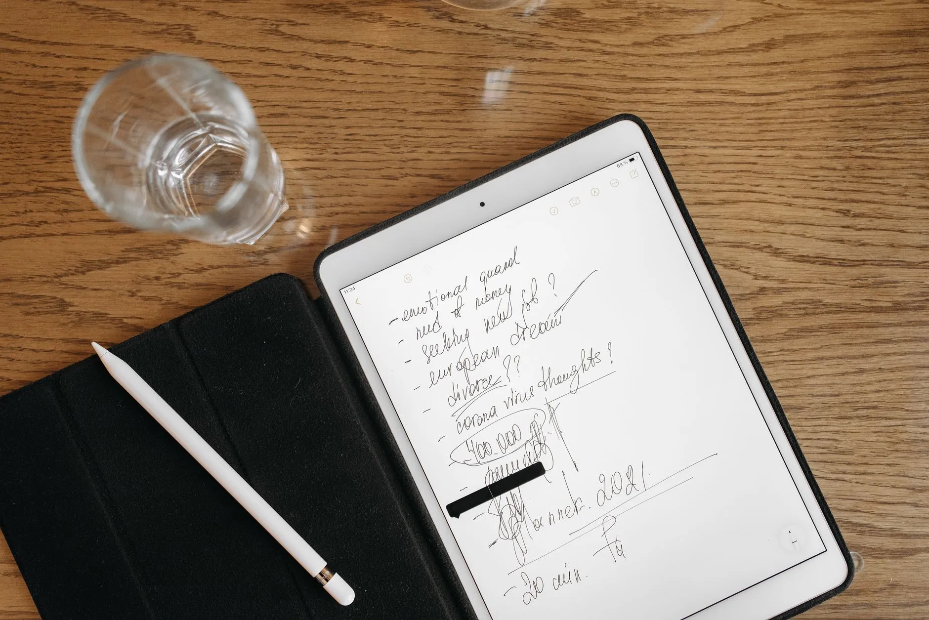 Close up of hands holding a tablet displaying digital notes on a cozy study desk