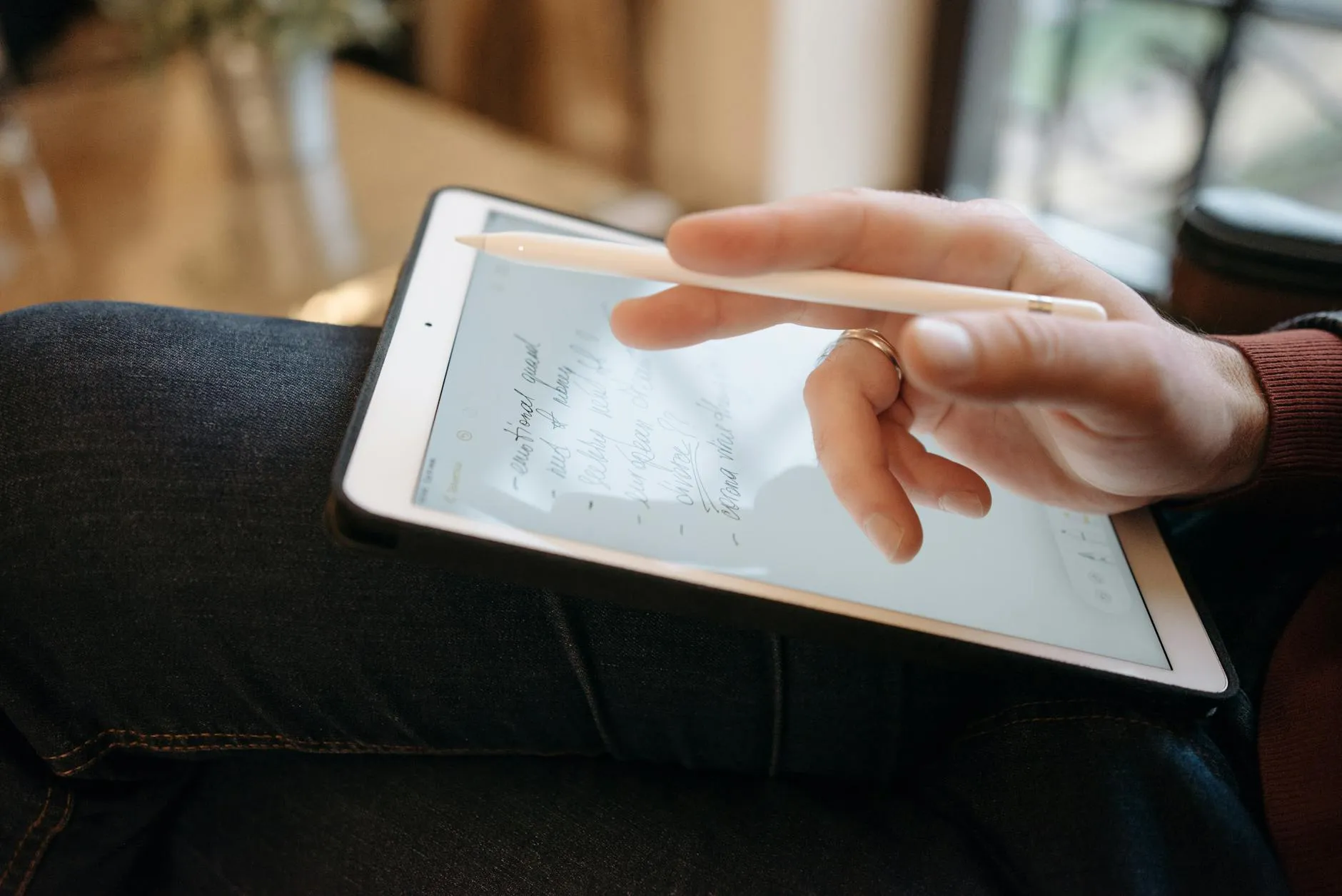 Detail shot of a student organizing digital notes on a tablet using the Cornell method