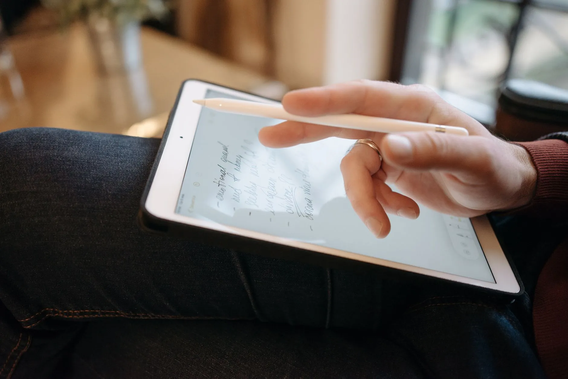 Close up of a student using a tablet to study fast with digital flashcards at a cozy dorm desk