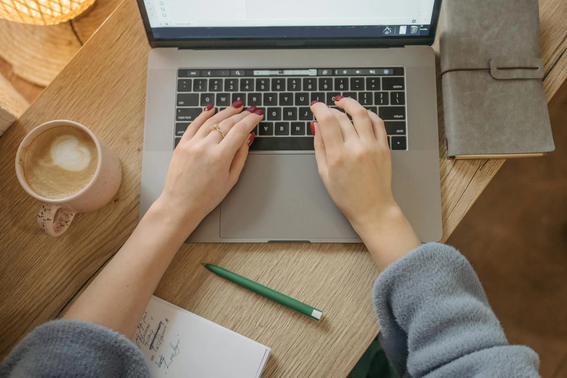 Detail shot of a student using AI tools on a laptop at a messy desk