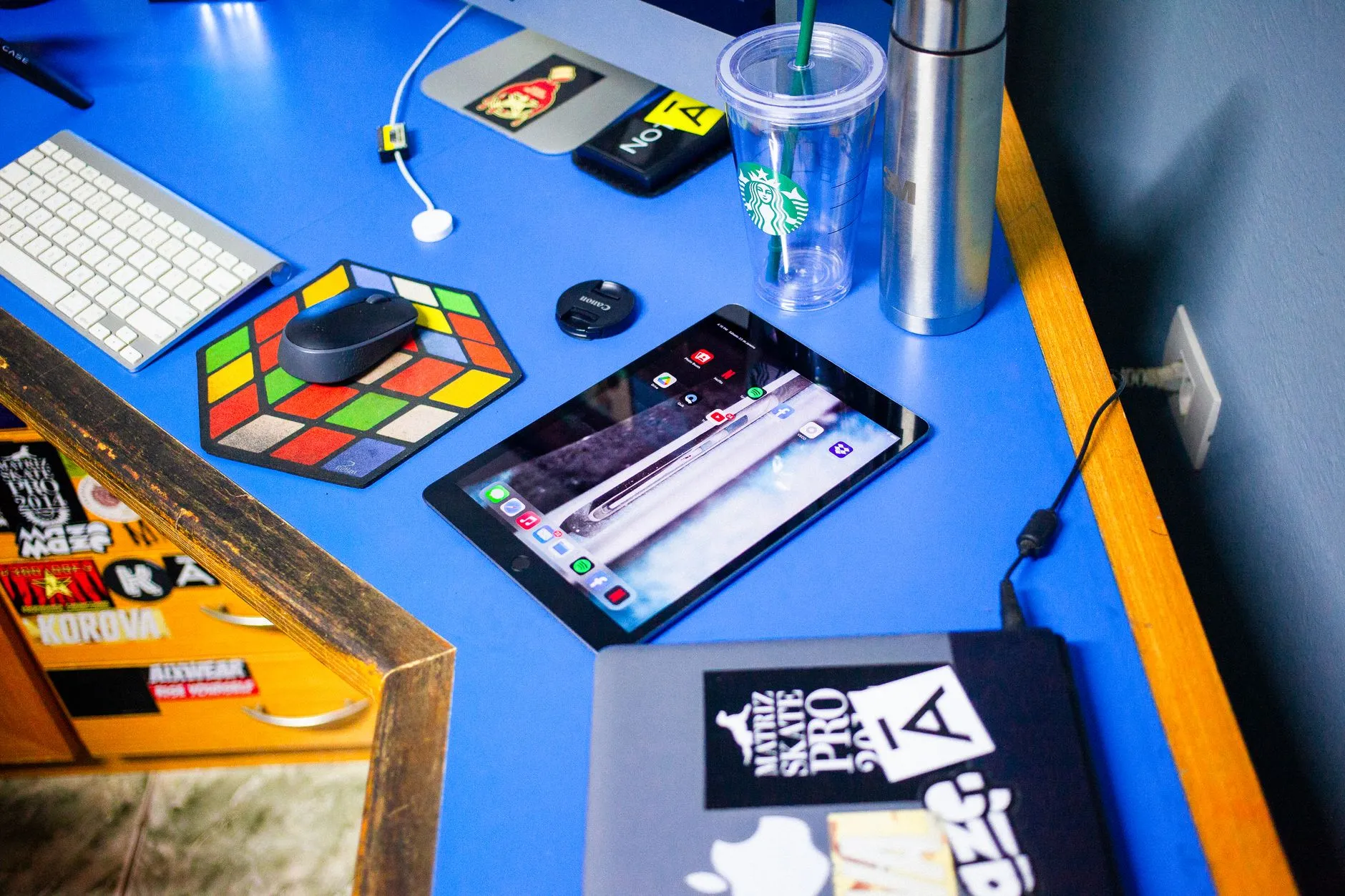A close up shot of a messy study desk with a tablet showing flashcards and a coffee cup