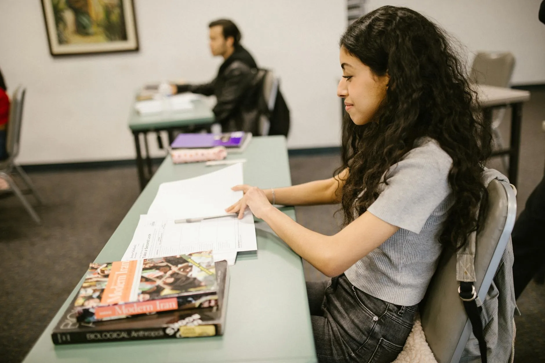 Close-up of a student's desk with notes and flashcards for different academic topics.