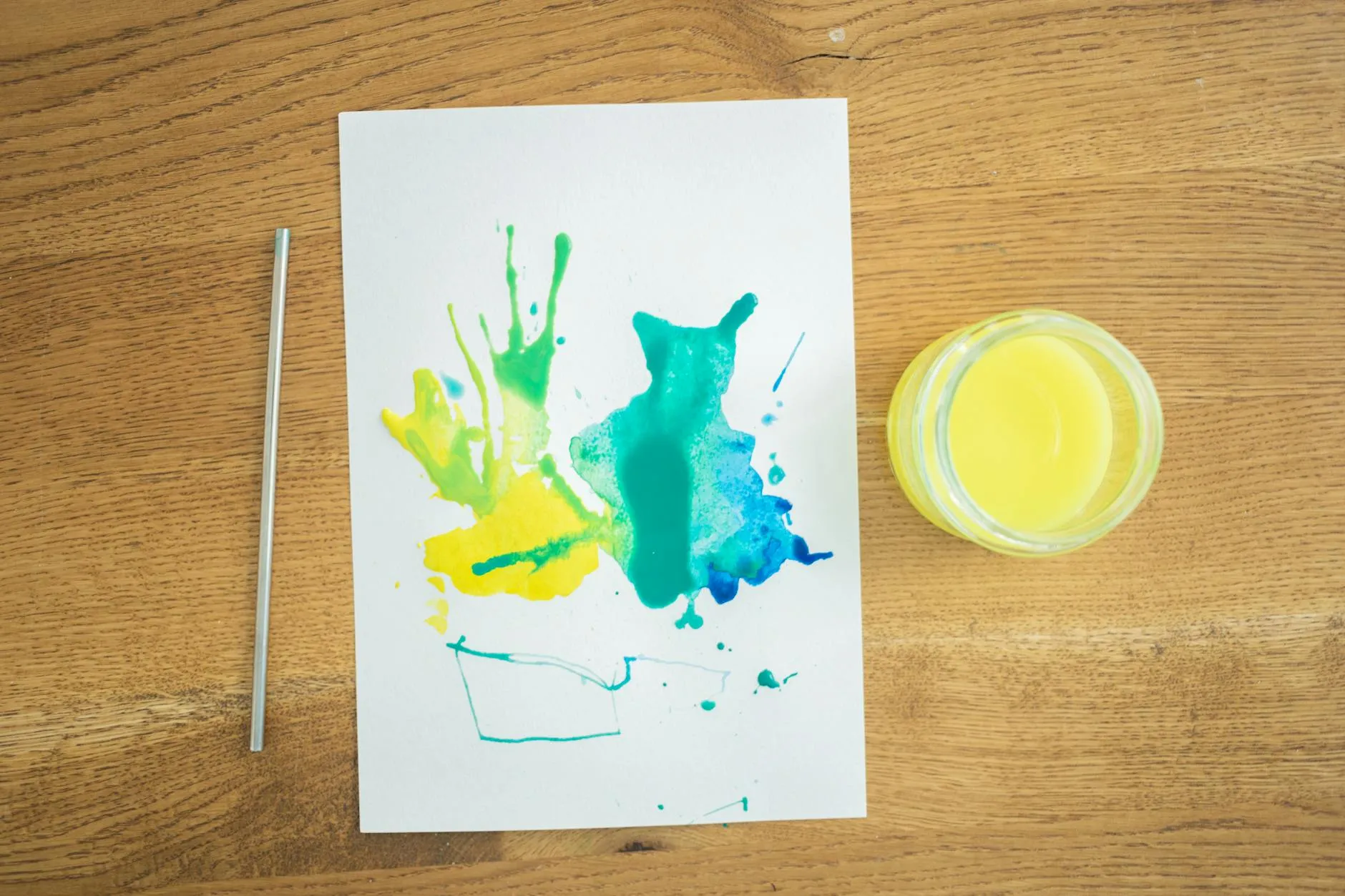 Close-up of a student's hands creating digital flashcards on a tablet amidst a messy dorm room study desk.