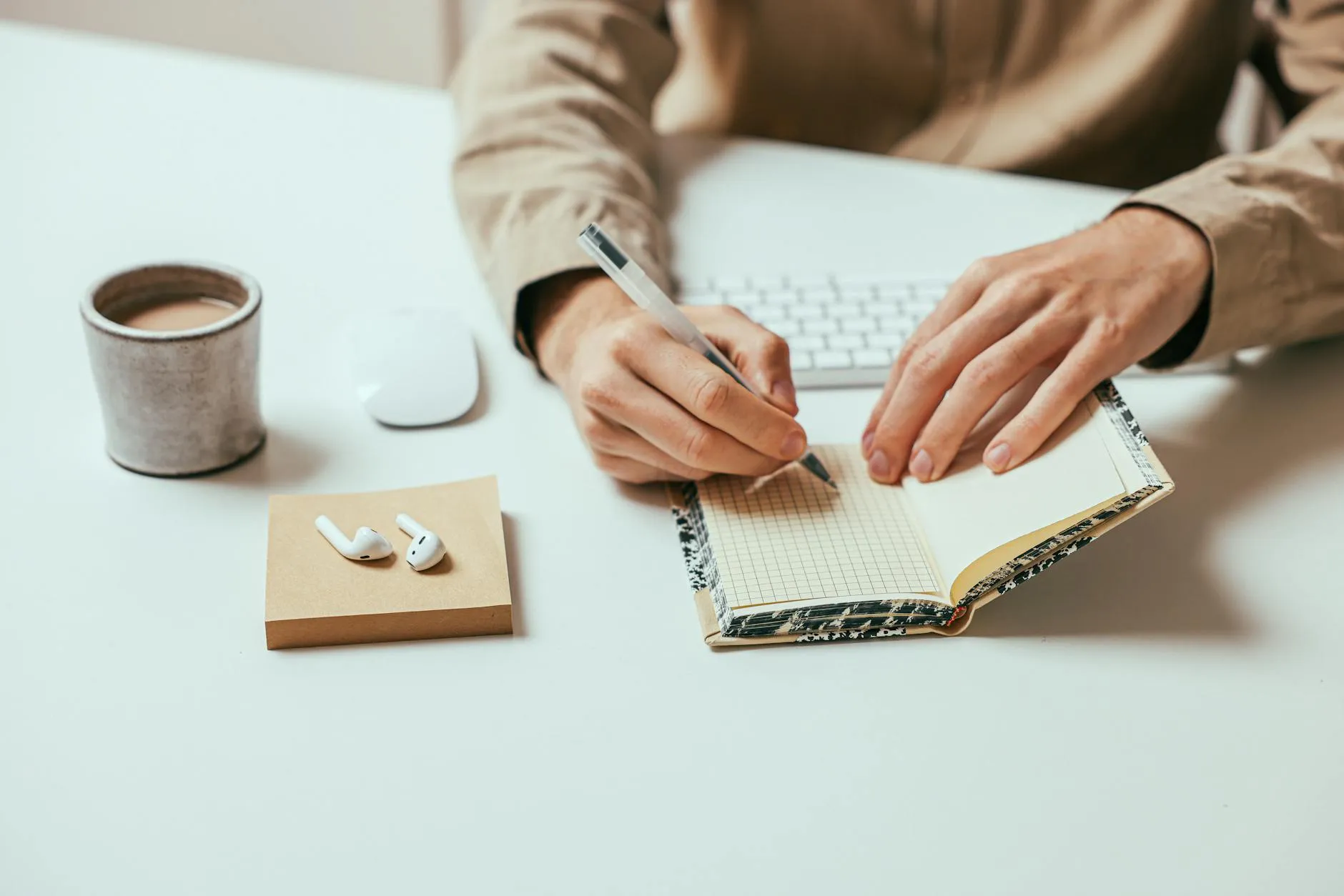 Close up of student hands organizing digital notes on a tablet at a cozy wooden desk
