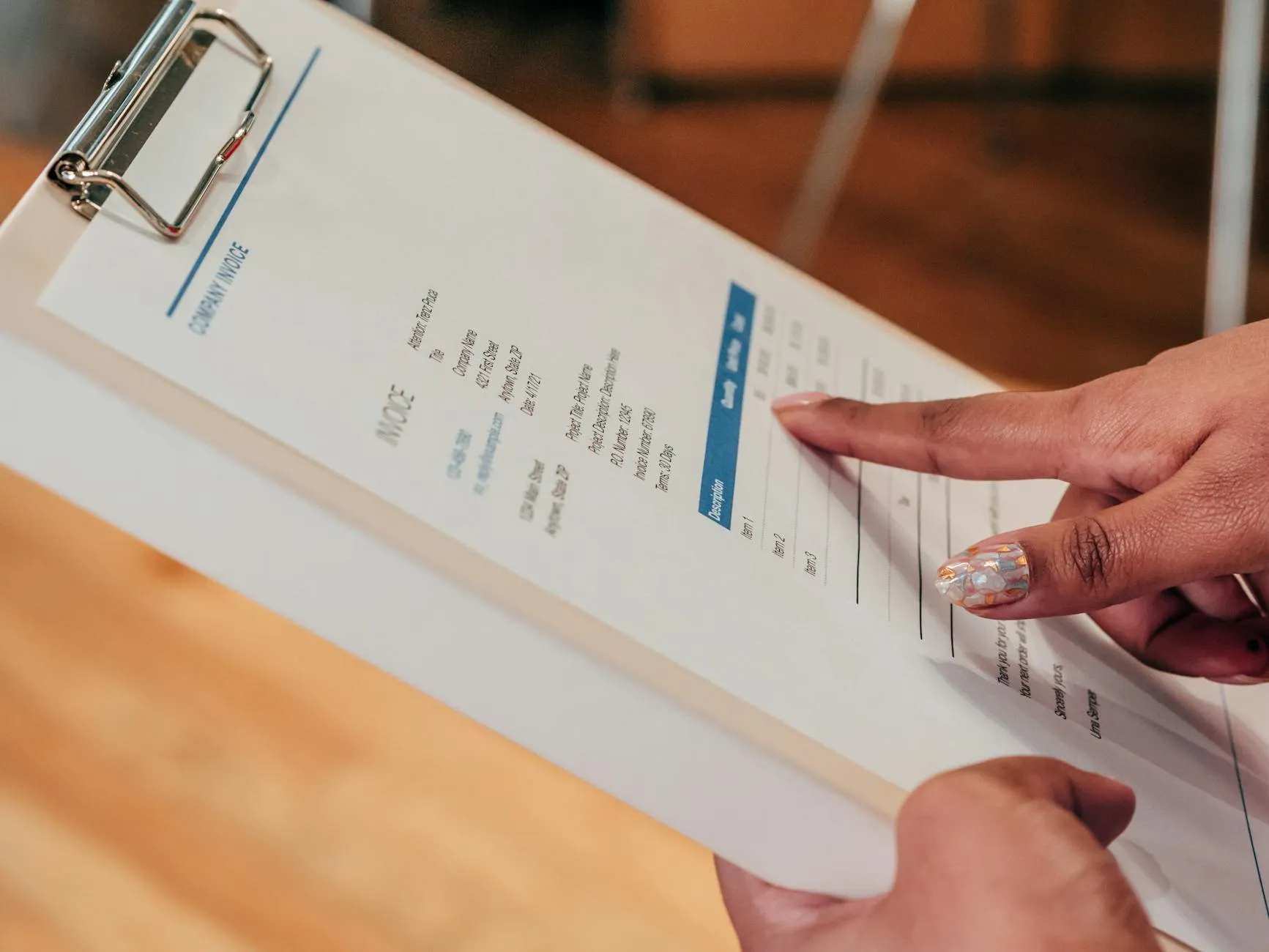 Close-up of a student's hands creating digital flashcards on a tablet amidst a messy dorm desk