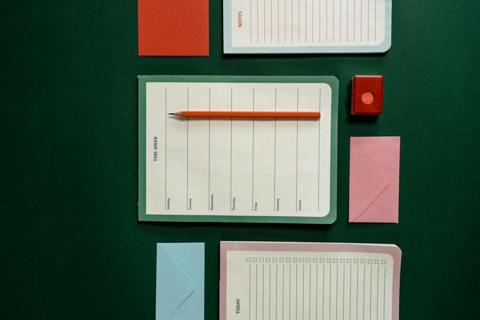 Close-up of a student's hands organizing a planner next to a coffee cup on a messy study desk, showing a practical morning routine.