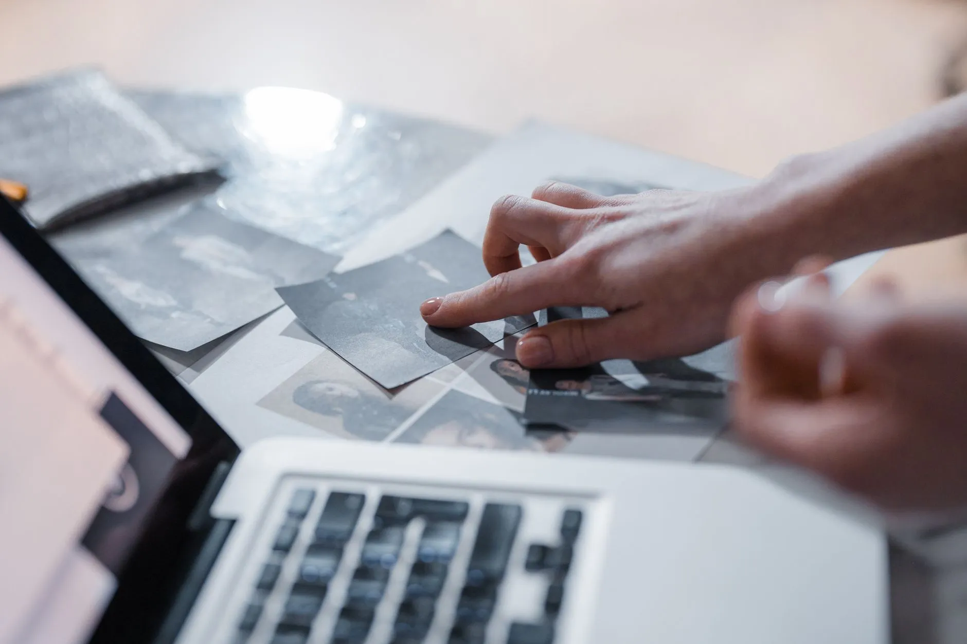 Close up of student hands organizing digital flashcards on a tablet at a messy wooden desk