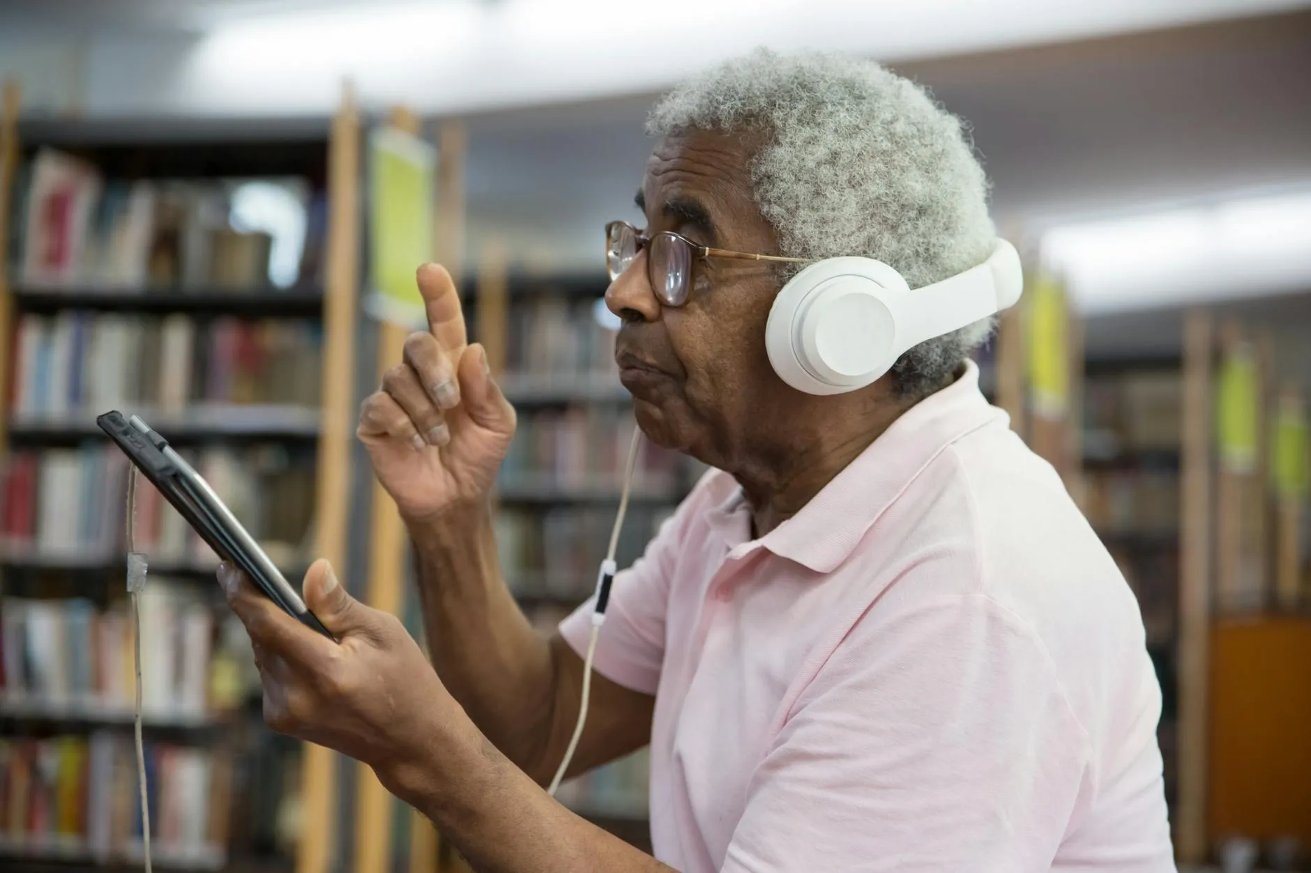Close up of hands using a digital tablet for flashcard study in a library