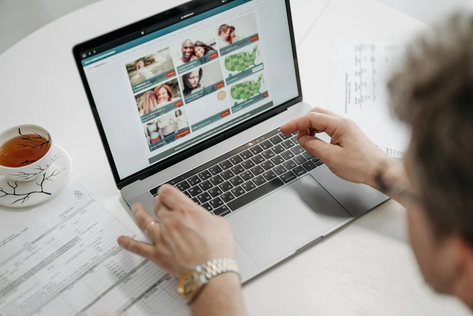Close up of a student using a laptop for research in a modern university library