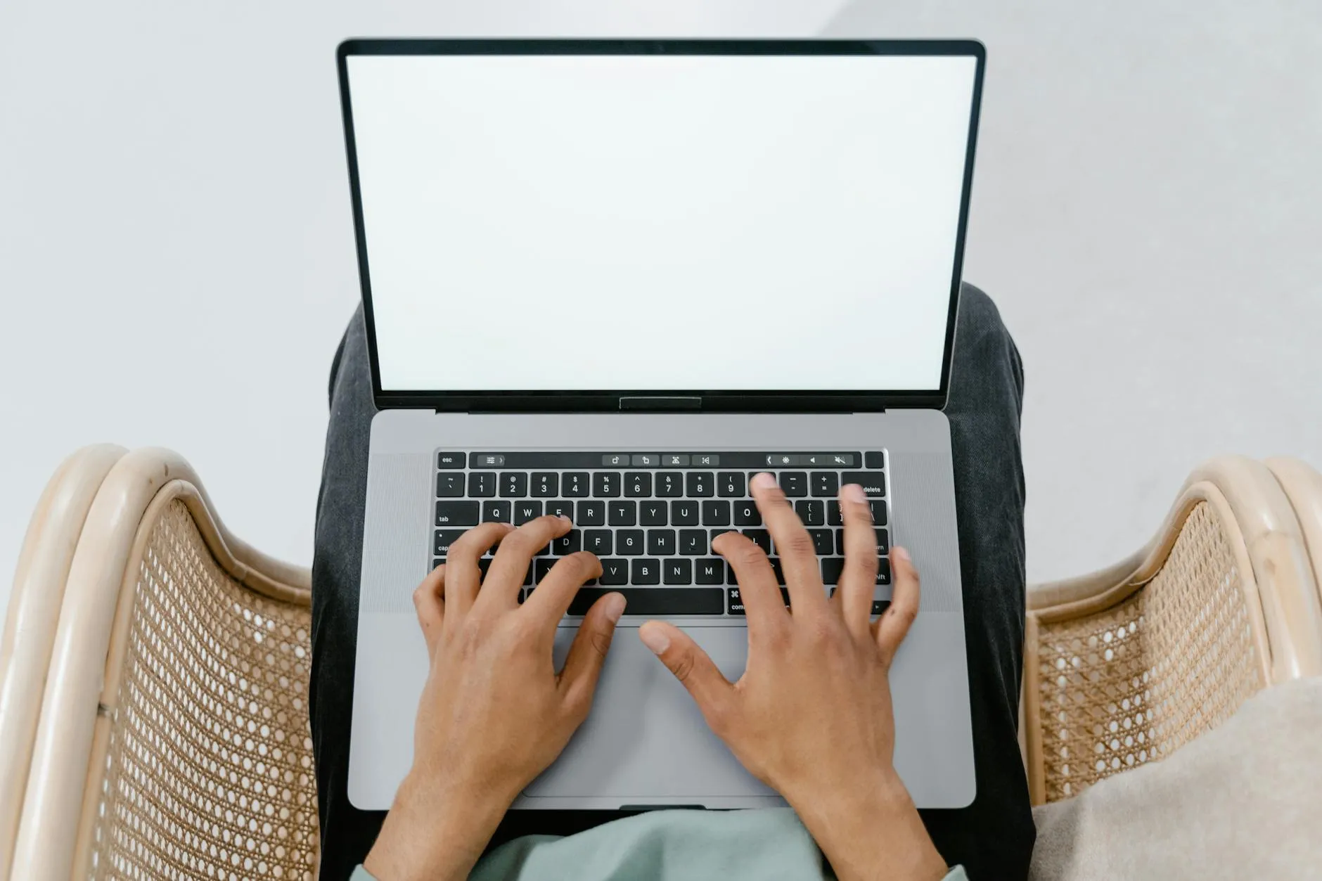 Close-up of a student's hands using a tablet to create flashcards on a messy dorm room desk, applying active recall.