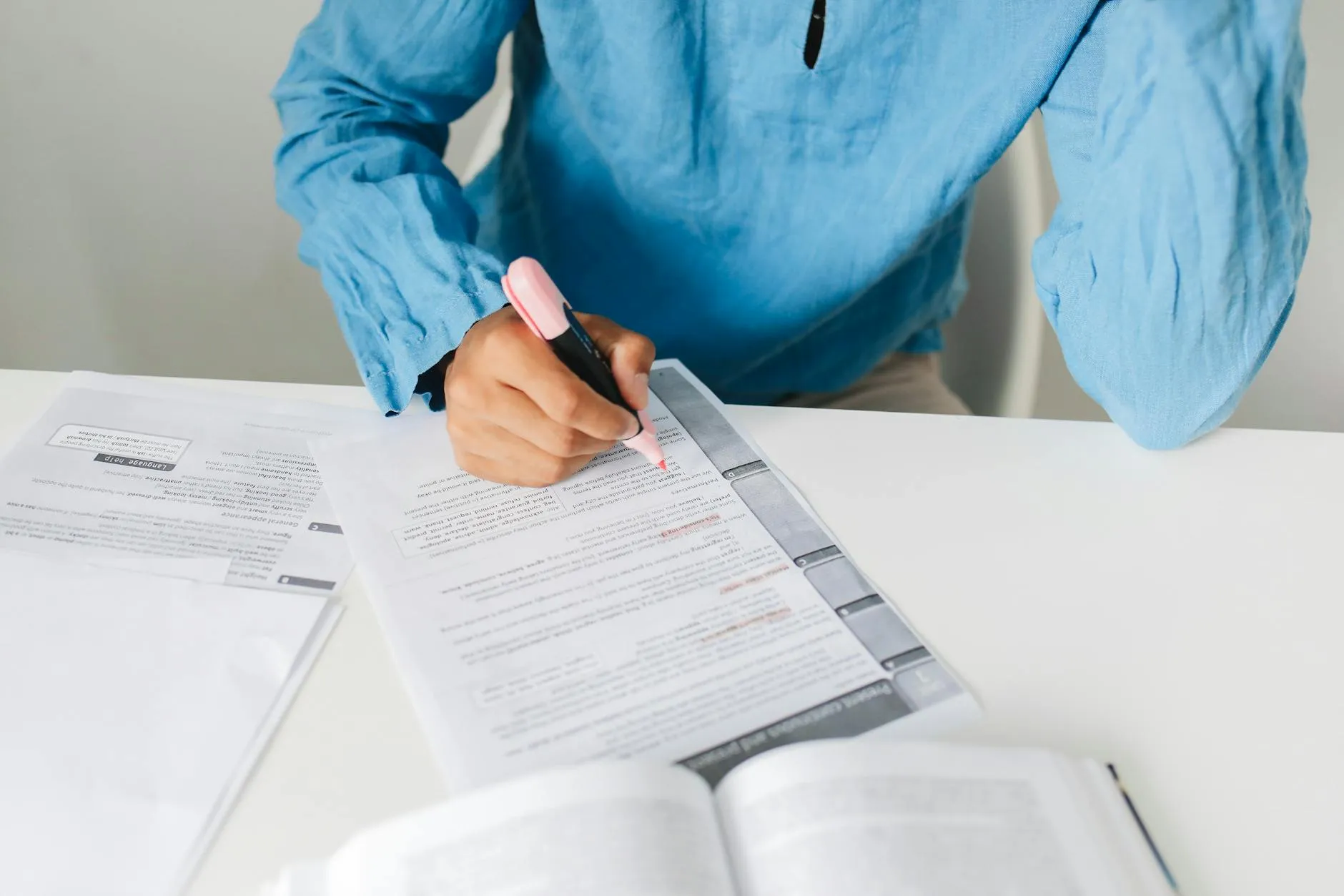 Close-up of student's hands reviewing digital flashcards on a laptop at a messy dorm desk