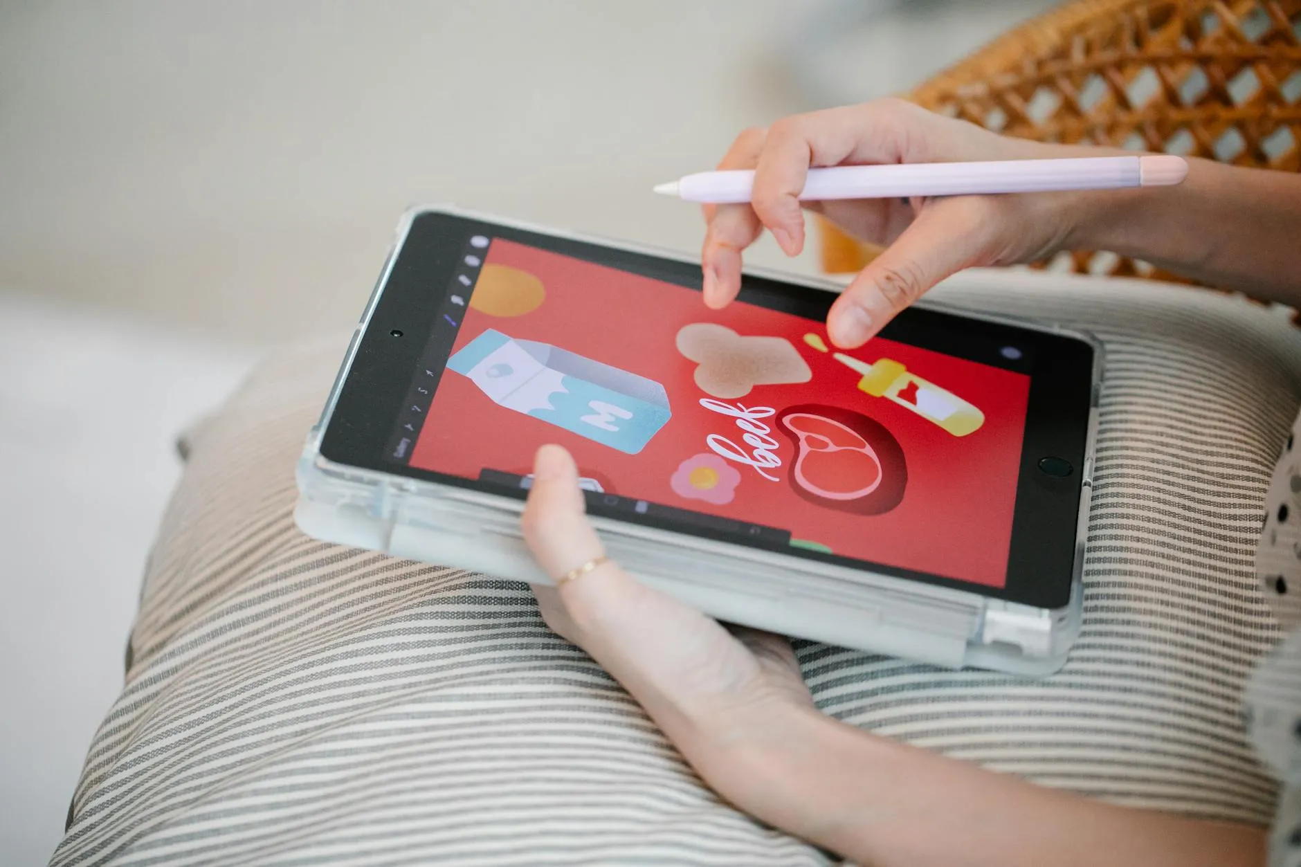Close up of a student using a tablet to study on a messy desk with stickers and a hydro-flask