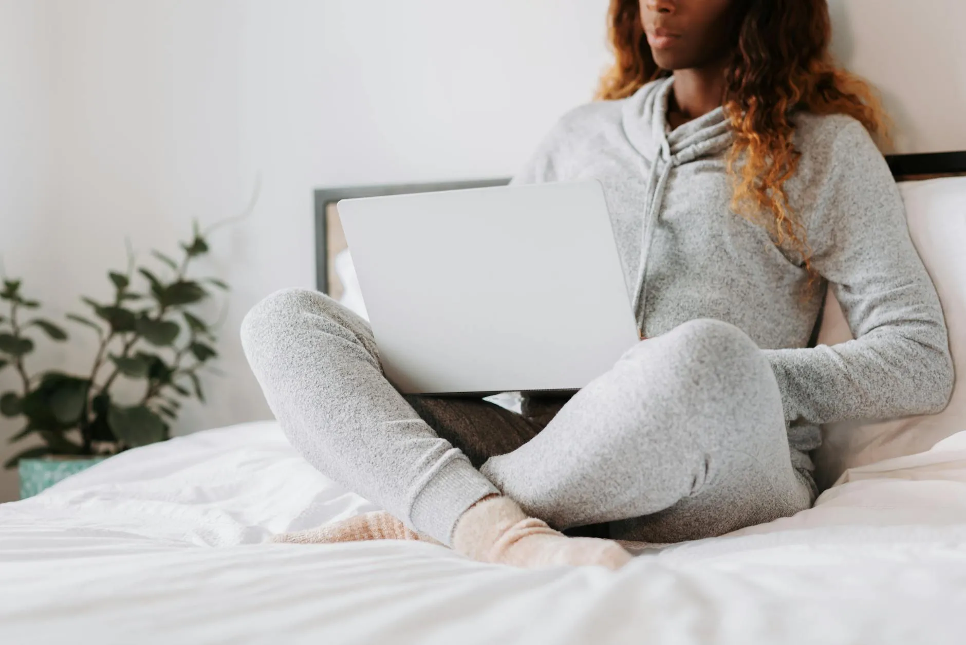 Close up of a student using a tablet for light reading in a cozy bed with warm lighting